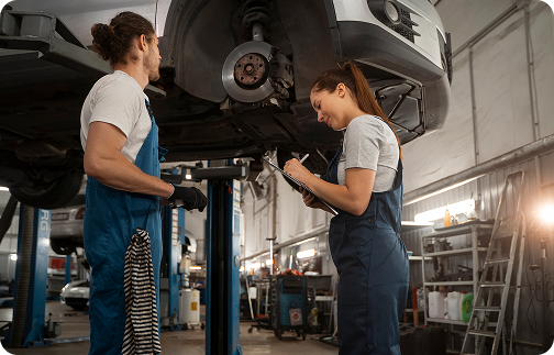 Service Images: male-female-mechanics-working-shop-car
